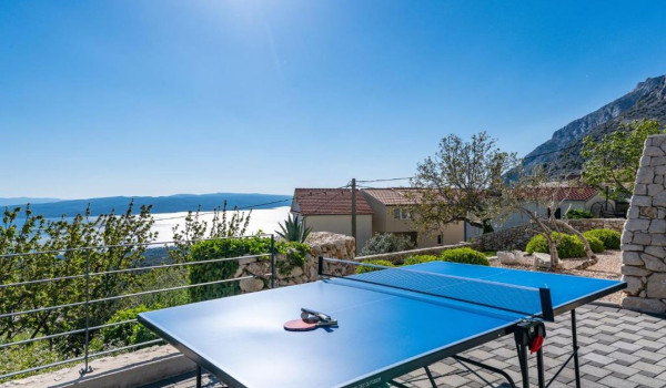 A table for table tennis on the property of a Croatian luxury villa for a perfect vacation with friends in Baška Voda