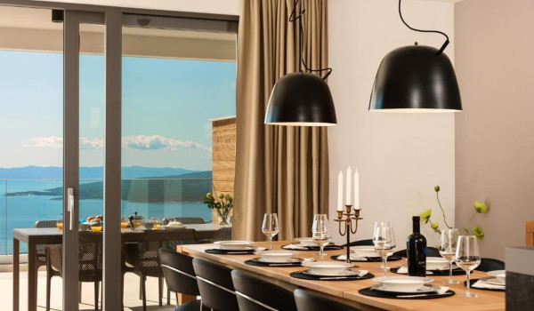 Richly arranged dining table with chairs with a beautiful view of the Croatian archipelago