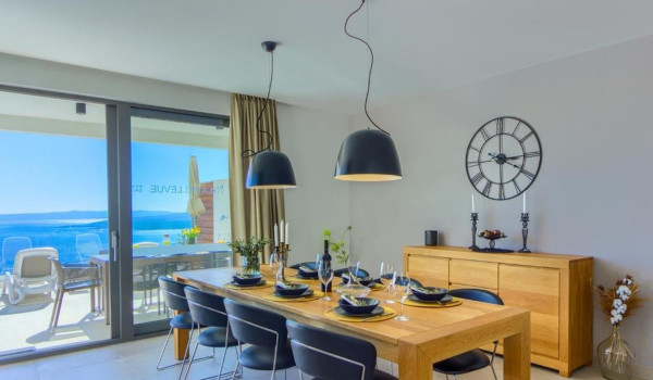 Richly arranged dining table with chairs with a beautiful view of the Croatian archipelago