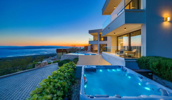 Exterior of White Diamond Croatian luxury villa with heated pool and jacuzzi in a beautiful sunset