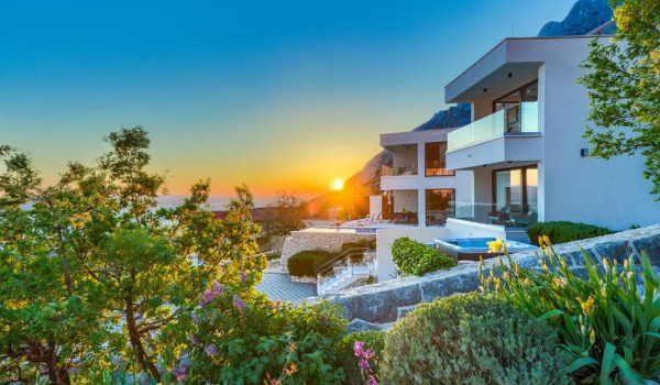Exterior of White Diamond Croatian luxury villa with heated pool and jacuzzi in a beautiful sunset