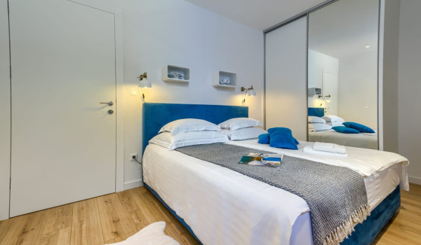 A modern bedroom in a sea style with a king-size bed in one of the bedrooms of a Croatian luxury villa