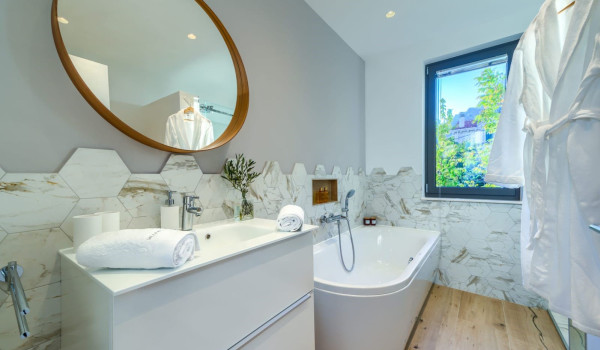 Luxuriously decorated bathroom with bathtub and walk-in shower inside a luxury Croatian villa for rent and vacation