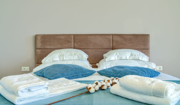 A luxuriously decorated bedroom with a king-size bed, exit to the terrace and numerous details