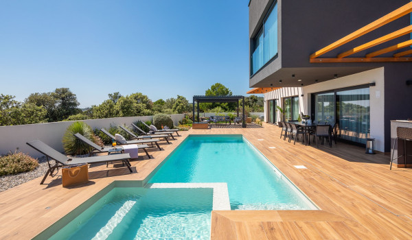 Sun loungers by the private pool in front of the entrance to the luxury Dalmatia vacation villa in Razanj