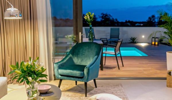 Exit from the living room to the spacious patio of the contemporary pet-friendly villa Indigo for rent and vacation