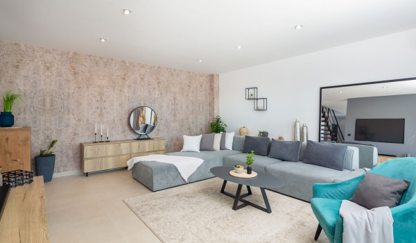 Comfortable angular sofa and a coffee tabla in the living room of the luxurious pet-friendly villa Indigo with pool