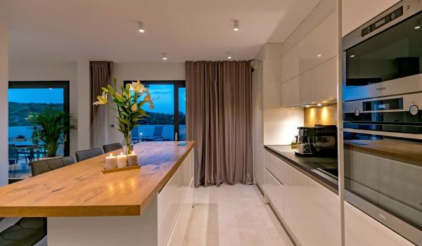 Modernly decorated kitchen with a kitchen island on the ground floor of the luxury pet-friendly villa Indigo with pool in Razanj