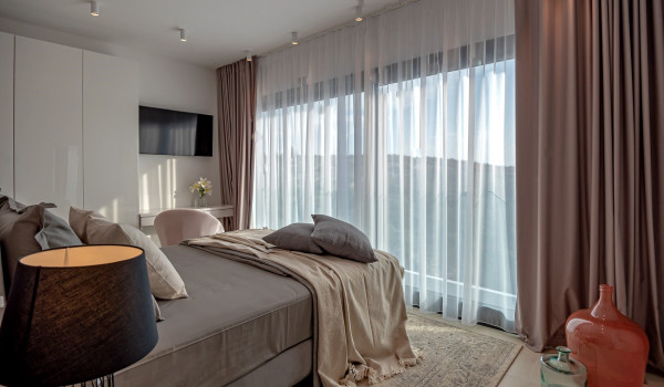 Private access to the balcony from the contemporary bedroom with a king size bed and an en suite bathroom