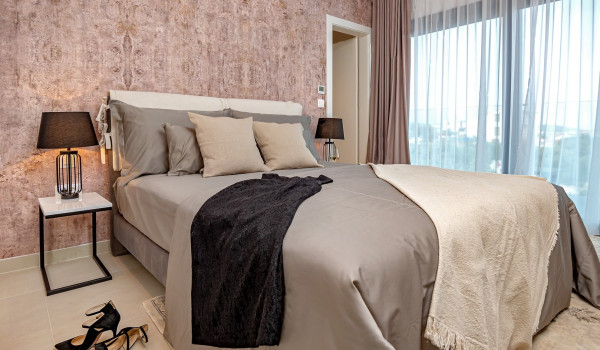 Elegant bedroom with a comfortable king size bed and a private access to the fenced balcony