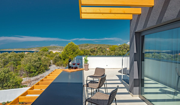 Private fenced balcony of the Croatia pet-friendly villa with pool with a seating area