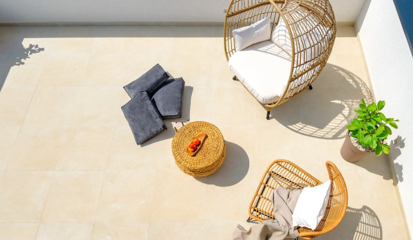 Seating area with a coffee table on the private fenced terrace of the luxury pet-friendly villa with pool