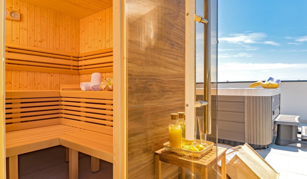 Interior of the private sauna and a jacuzzi on the roof patio of the modern rental home Indigo with private pool in Razanj