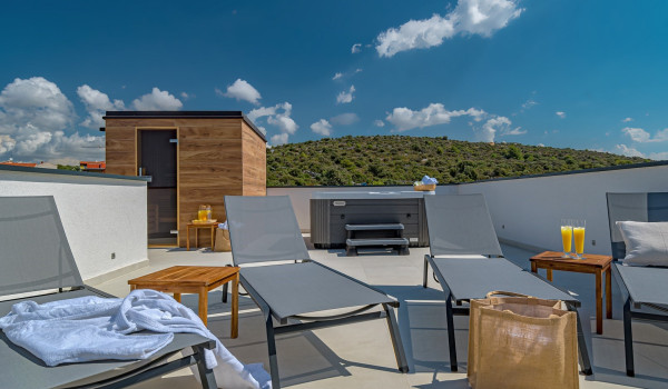 Sun loungers next to the private sauna and jacuzzi on the roof terrace of the luxurious villa for rental with private pool in Razanj