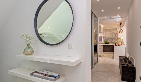 Seating area and mirror in the corridor on the ground floor of the modern villa Velvet Bourbon Split with pool