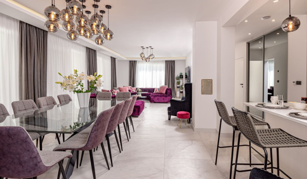 Modern interior of the dining room and living room and the kitchen island on the ground floor of the villa with pool Velvet Bourbon Split