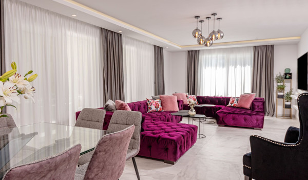 View from the dining room to the comfortable modern sofa in front of the LCD TV in the living room