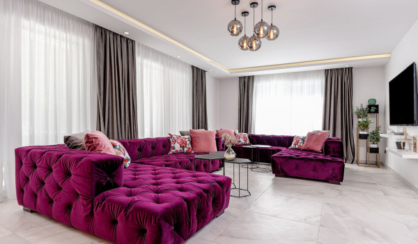 LCD TV in front of the spacious modern corner sofa in the living room on the ground floor of the luxury villa Velvet Bourbon Split