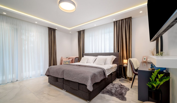 Bedroom with king size bed, seating area, LCD TV and private exit to the balcony inside Croatian luxury holiday villa