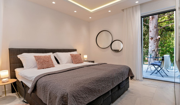 King size bed and its own exit to the terrace from the modern bedroom in the family holiday villa with pool