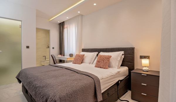 Comfortable king size bed and seating area in the bedroom of the luxury villa Velvet Bourbon Split