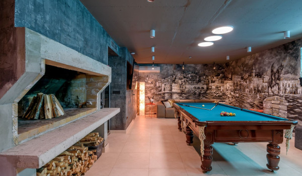 Wood for the fireplace and billiards in the basement of the luxury villa with pool by the sea