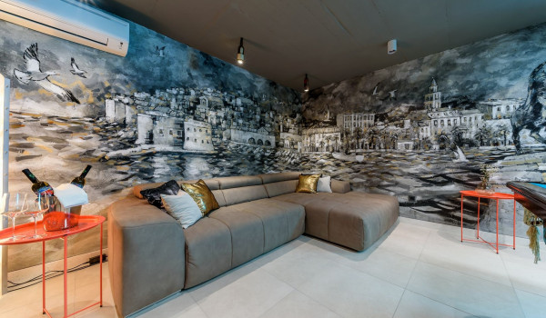 Comfortable corner sofa next to the pool table in the air-conditioned entertainment room