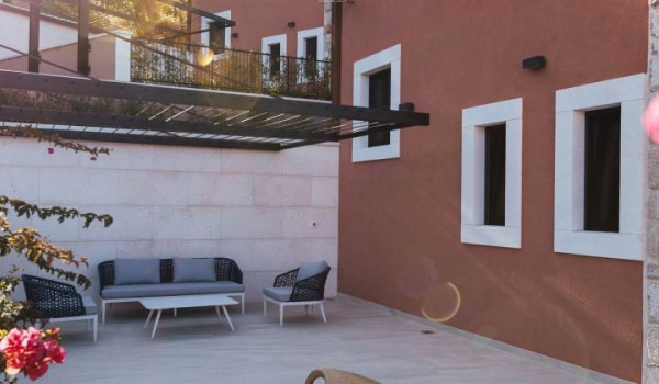 A view of the covered seating area and modern leaf-shaped lounge chairs on the property of a Dalmatian luxury holiday villa