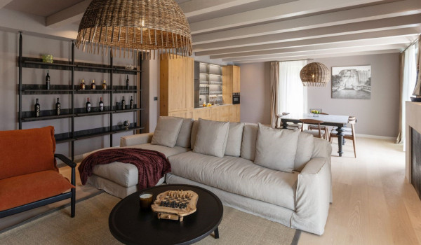 A richly decorated living room with a comfortable sofa and TV on the ground floor of a modern villa for rent and vacation