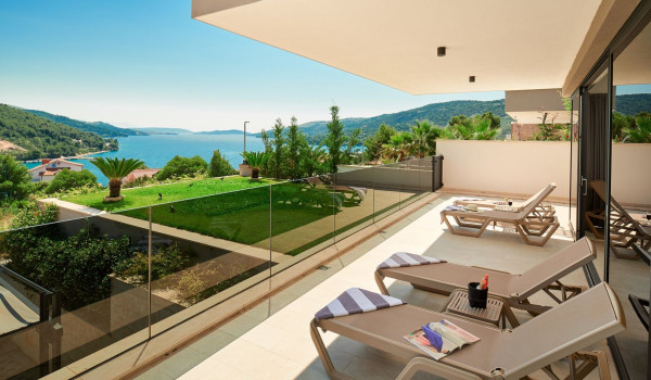 Sea view from the sun loungers on the fenced terrace of the luxury Dalmatian villa Thalia with an indoor pool