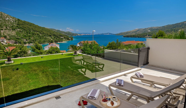 Sun loungers on the fenced terrace with a sea view in the luxury villa Thalia in Marina