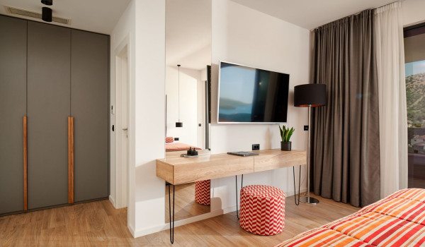 Wardrobe and SAT TV in the spacious bedroom of the modern villa for rent and vacation