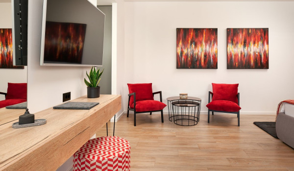 SAT TV and a seating corner in the spacious bedroom of the modern villa for holiday Thalia near Trogir