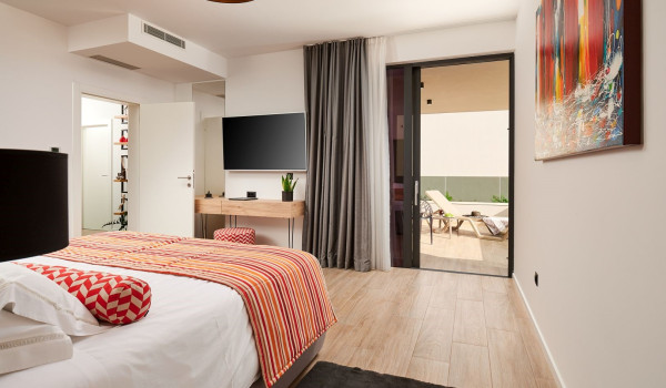 Spacious bedroom with a king size bed, SAT TV and exit to the balcony of the luxury Dalmatian villa Thalia