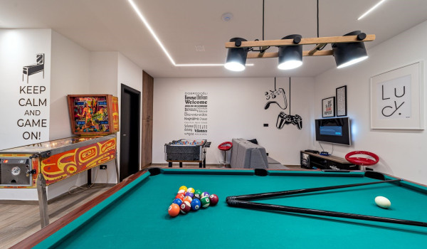 Billiards table and pinball machine in the game room of the home for family vacations Thalia near Trogir