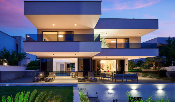 Illuminated garden and property of the modern villa for vacation Thalia with an indoor pool in Marina