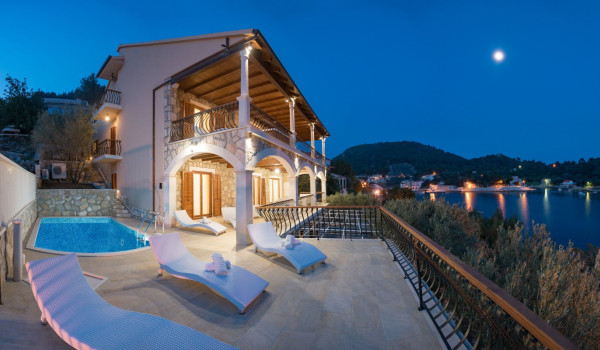 Deck chairs by the pool on the terrace of the luxury pool villa Korcula Magnificent at the beach