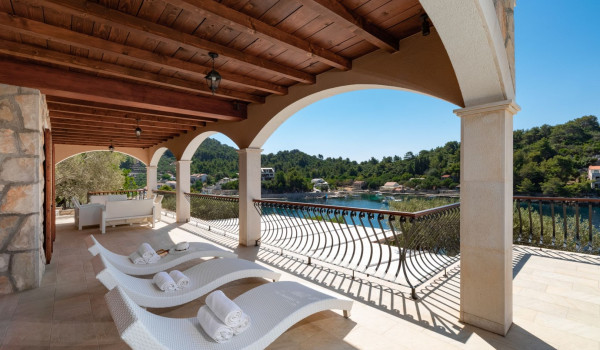 Sun loungers by the pool of the luxury vacation villa Korcula Magnificent with concierge service