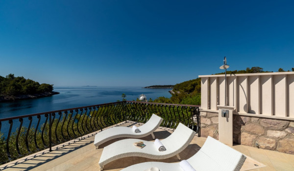 Deck chairs and outdoor shower on the terrace of the luxury Korcula villa with sea view