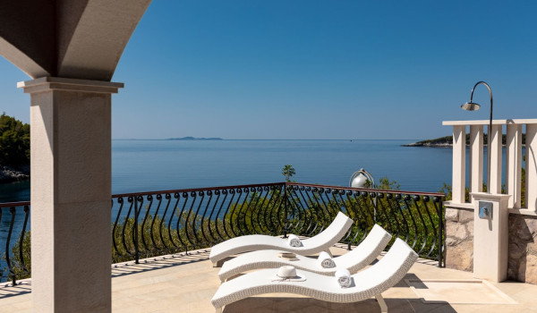 Deck chairs and outdoor shower on the terrace of the luxury Korcula villa with sea view