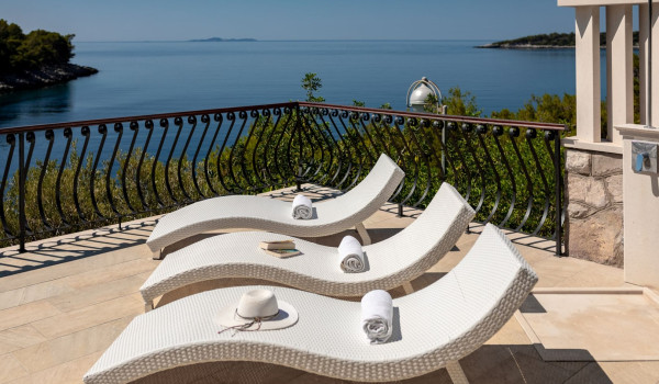 Deck chairs and outdoor shower on the terrace of the luxury Korcula villa with sea view