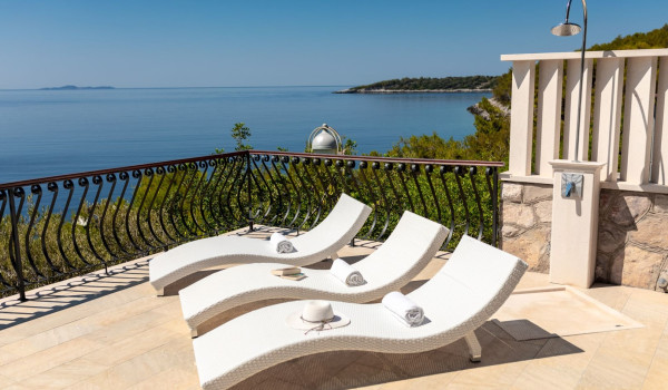 Deck chairs and outdoor shower on the terrace of the luxury Korcula villa with sea view
