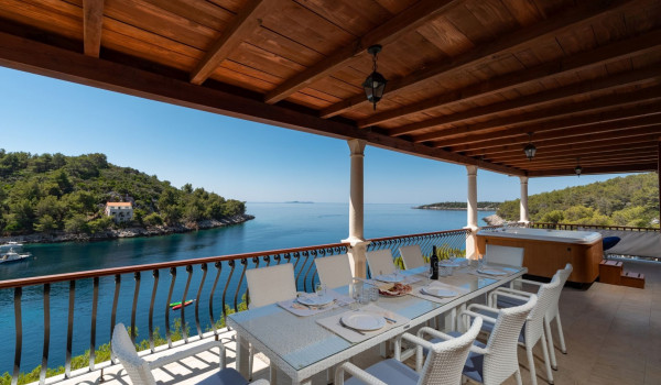 Outdoor dining table on the balcony of the luxury vacation villa for families with kids in Korcula island
