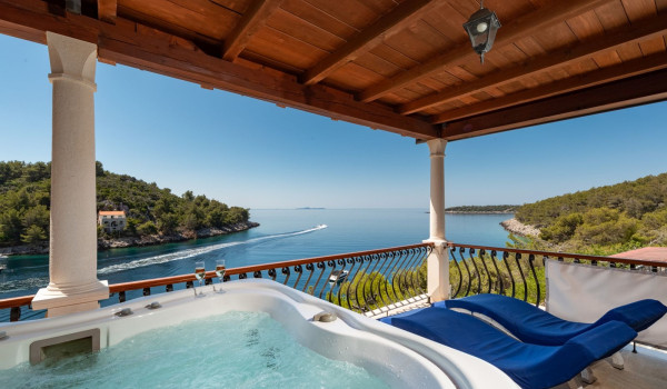 Private jacuzzi and sun loungers on the balcony of the luxury holiday villa on Korcula island with concierge service and private parking