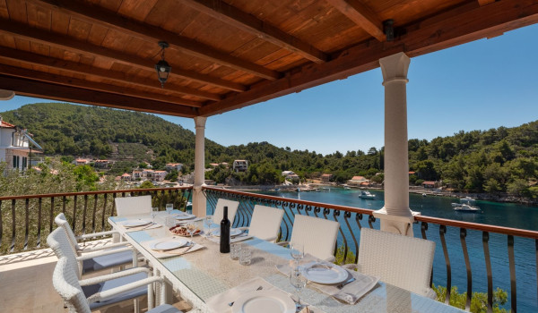 Dining table with sea view on the balcony of the luxury beachfront villa for family vacation on Korcula