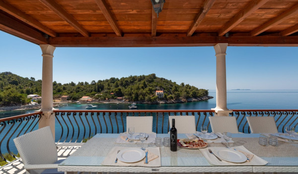 Dining table with sea view on the balcony of the luxury beachfront villa for family vacation on Korcula