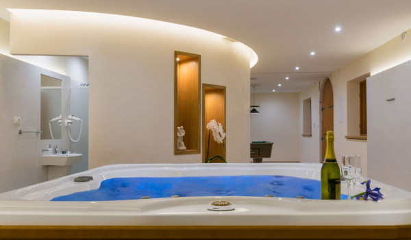 Indoor jacuzzi in a wellness room of the luxury vacation villa with private pool and private parking