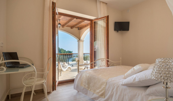 Double bed in a bedroom with direct entrance to the terrace of the luxury vacation villa at the beach on Korcula island