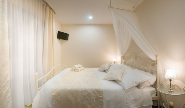 Elegant double bed with baldachin in a bedroom of a luxury holiday villa Korcula Magnificent with concierge service and private mooring