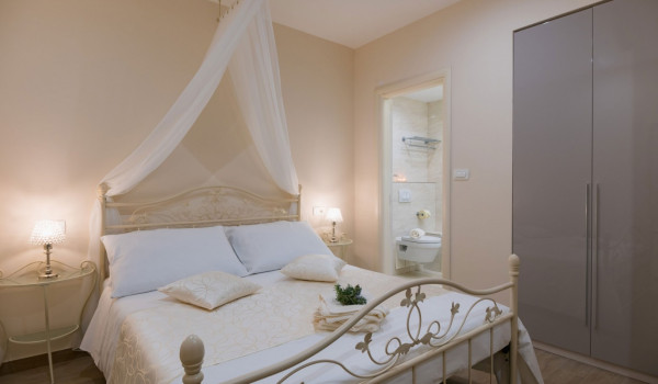 Elegant bedroom with double bed and en suite bathroom of a luxury beachfront villa Korcula Magnificent with private heated pool